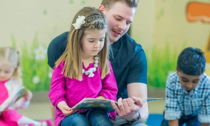 Père et fille lisant un livre d'apprentissage de la lecture